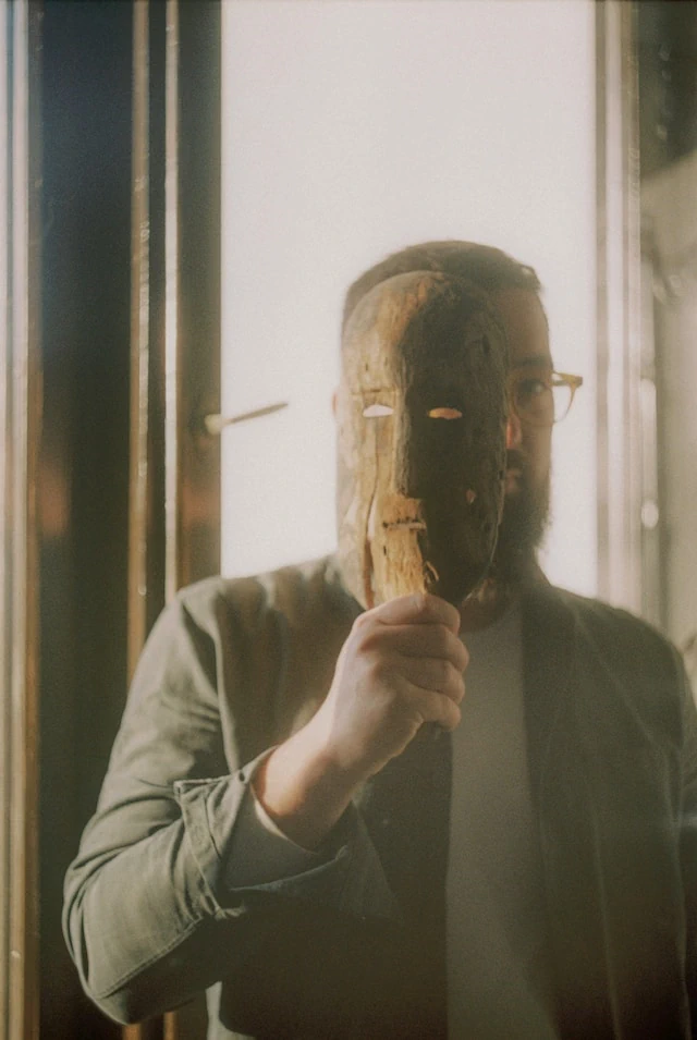 Man hiding identity behind mask
