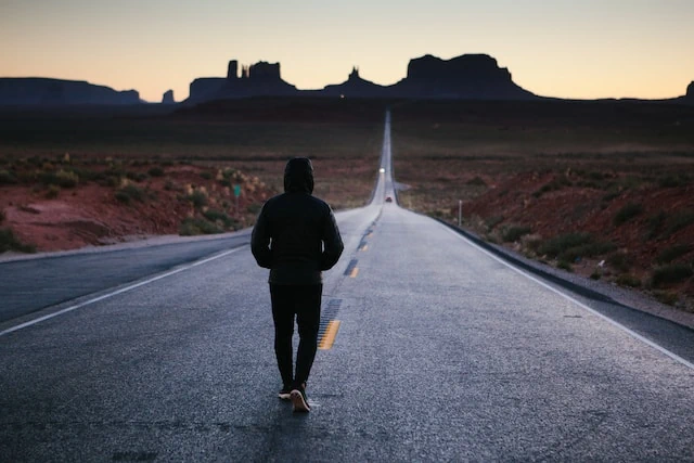 Man walking towards city