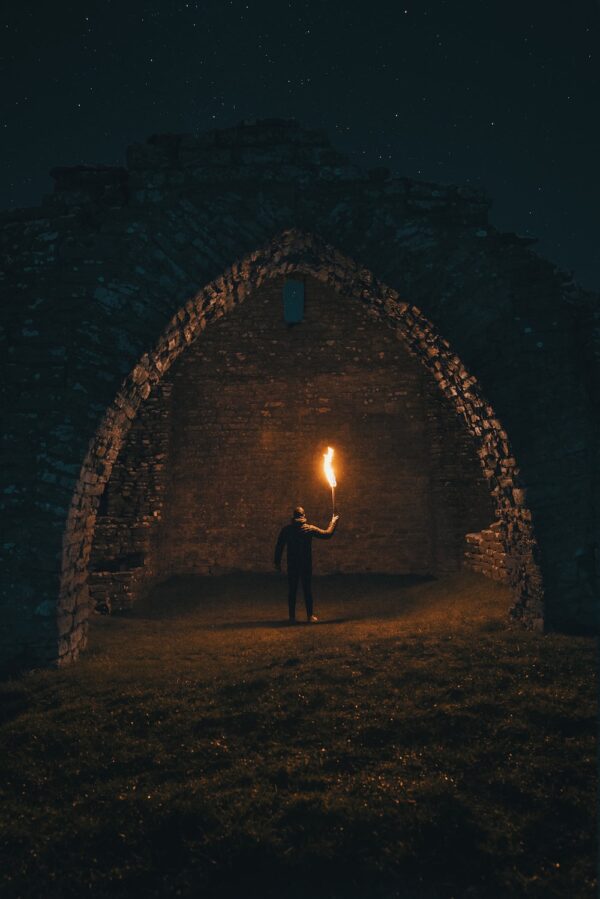 Man in darkness with a torch